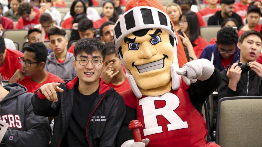 Photo of a Rutgers students with Scarlet Knight