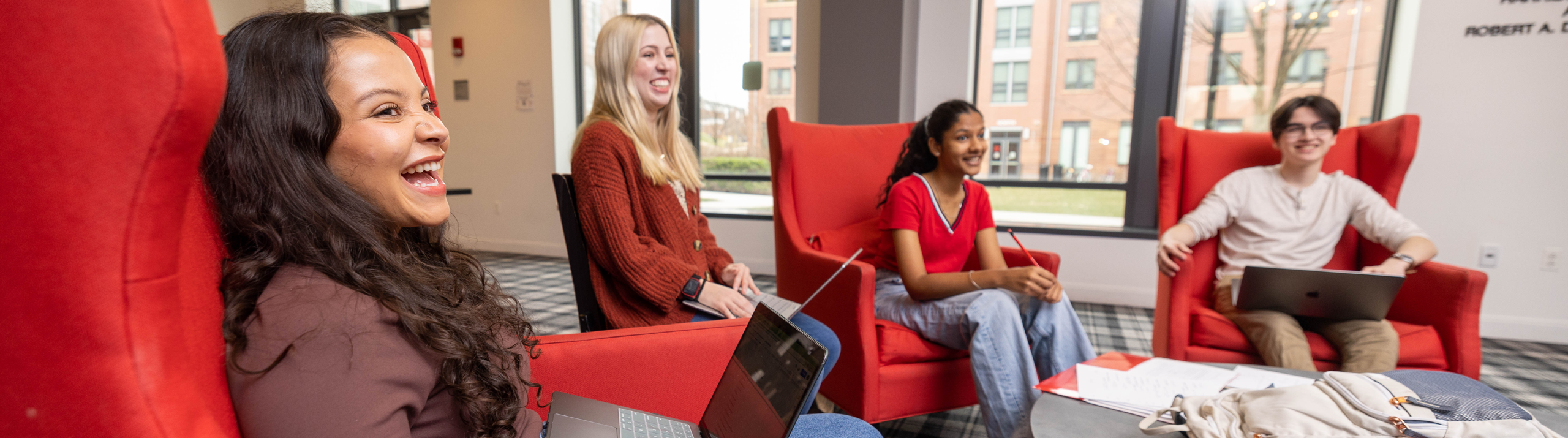 Honors College students sitting in a lounge and smiling