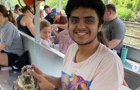 Photo of Anish Suresh with alligator