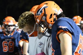 Student coaching other student football players