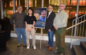 Photo of Phong Nguyen (left) with an Honors College student, Honors College Dean and a professor of English, Richard E. Miller