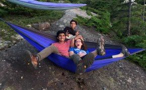 Shaheer (left) with friends in a mountaintop hammock.