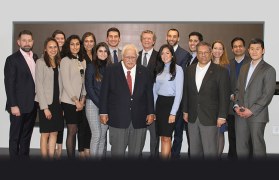 Members of five teams that made it to the final round of Rutgers Business School's annual business plan competition pose with sponsors, judges and organizer, Doug Brownstone, an assistant professor of professional practice.