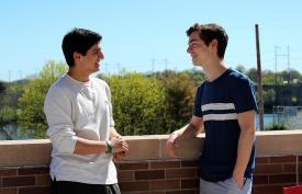 Eshan Kaul and Nick Pellitta standing on the Honors College terrace overlooking the Raritan River